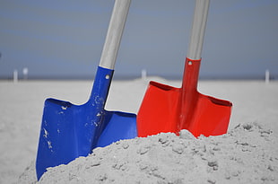 close up photo of two blue and red shovels HD wallpaper