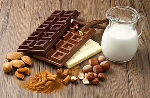 three chocolates and pitcher filled with milk HD wallpaper