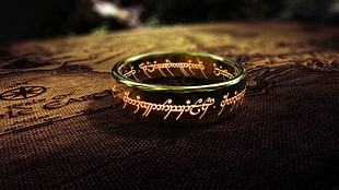 gold-colored ring with white text HD wallpaper