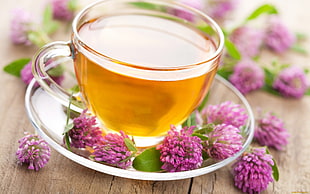 glass of tea on brown wooden table during daytime