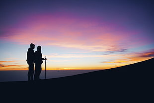 silhouette of two men standing