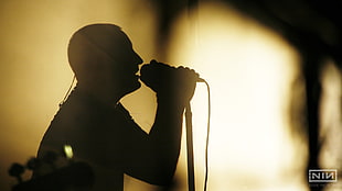 silhouette of man in front of microphone HD wallpaper