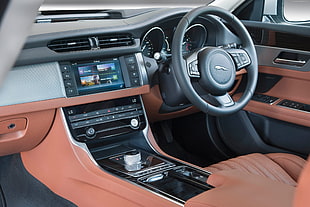 Jaguar vehicle steering wheel with turned on black center stack HD wallpaper