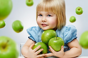 girl in blue dress holding green apples HD wallpaper
