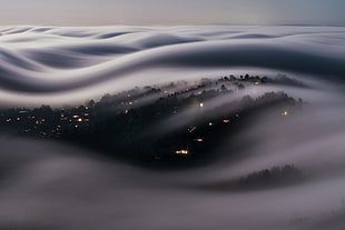 city under sea of clouds, cityscape, mist, long exposure