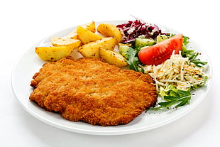 fried food and potatoes, vegetables on white ceramic plate
