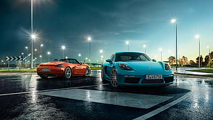 two orange and teal sports car parked on concrete ground HD wallpaper
