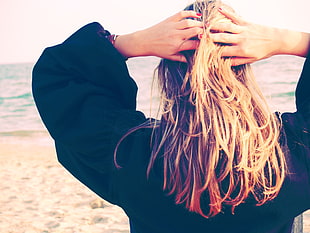woman in black jacket holding blonde hair HD wallpaper