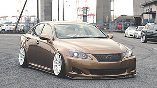 brown metallic Lexus Sedan on asphalt