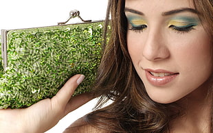 closeup photo of woman holding green beaded kisslock clutch bag HD wallpaper