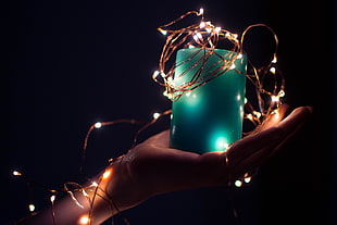 person hold blue candle with string lights HD wallpaper