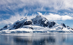 snow-capped mountains near sea at daytime