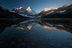 mountain near body of water under blue sky, magog