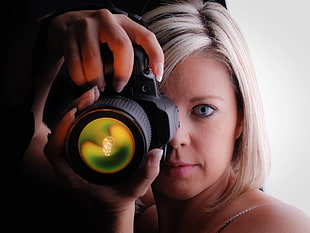 woman holding black DSLR camera HD wallpaper