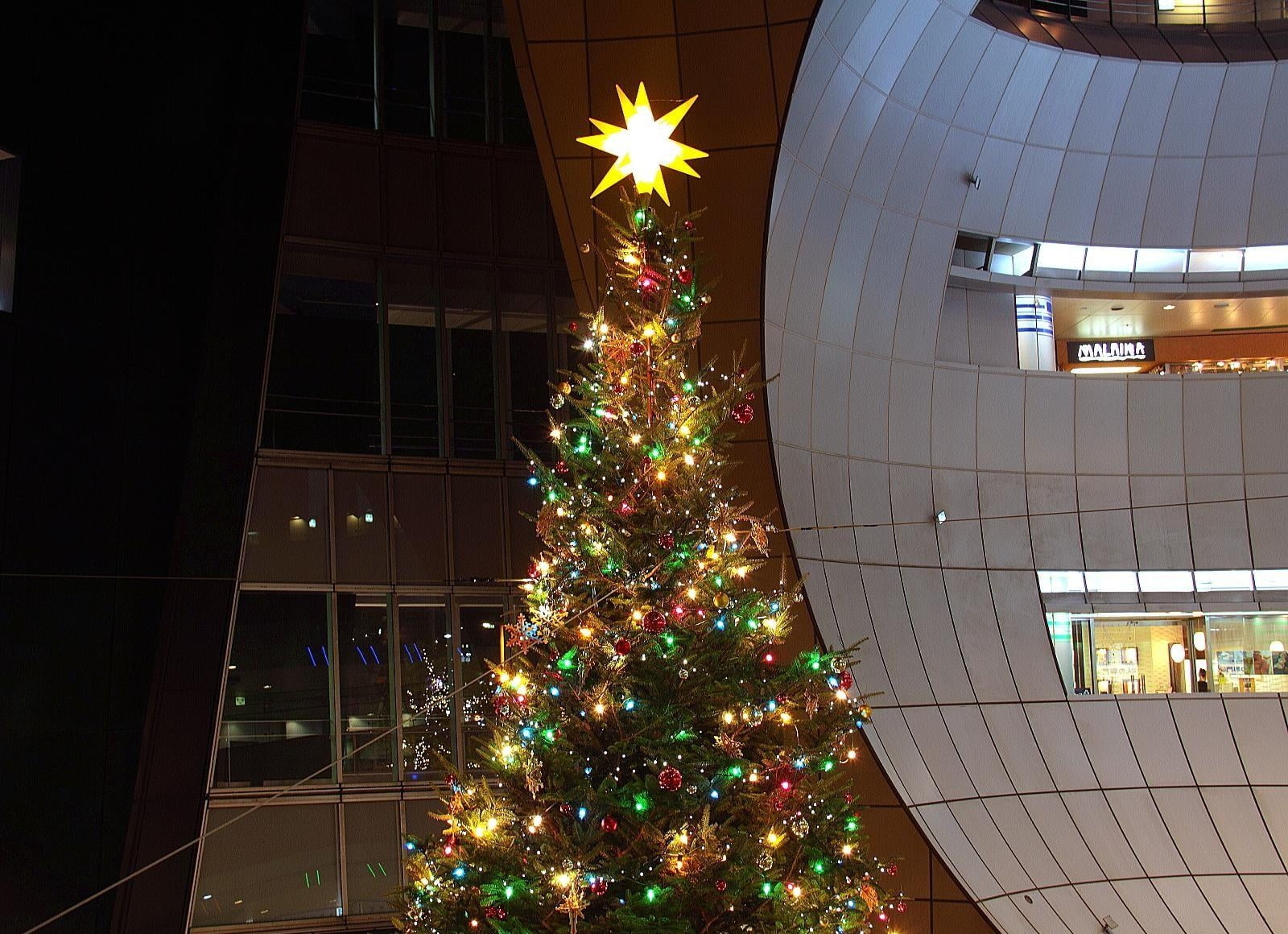 green Christmas tree with string lights and ornaments