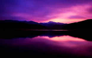 view of body of water near mountains during dawn HD wallpaper