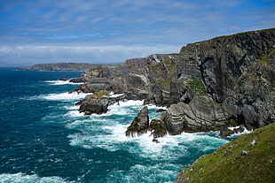 photo of rock formation on sea during daytime HD wallpaper