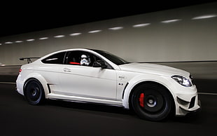 person in Storm trooper costume riding white sports car