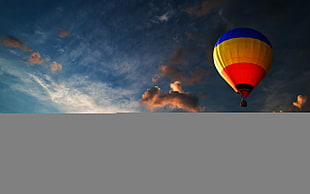 blue, yellow, and red hot air balloon photo durng sunset HD wallpaper