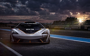 white racing car on asphalt road