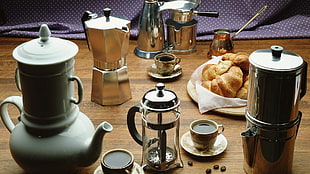 four Mocha pots and baked bread on table