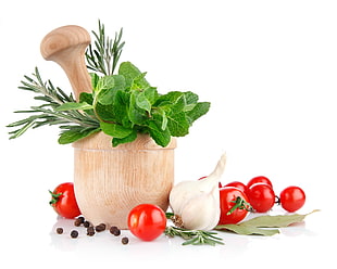 tomatoes and garlic near the vegetables on mortar