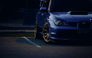 blue car on concrete road