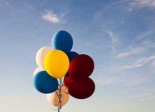 assorted-colored balloons floating on air under blue sky HD wallpaper