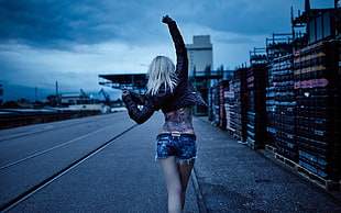 woman with tattoo covered back walking on road, women, jean shorts, tattoo, leather jackets HD wallpaper