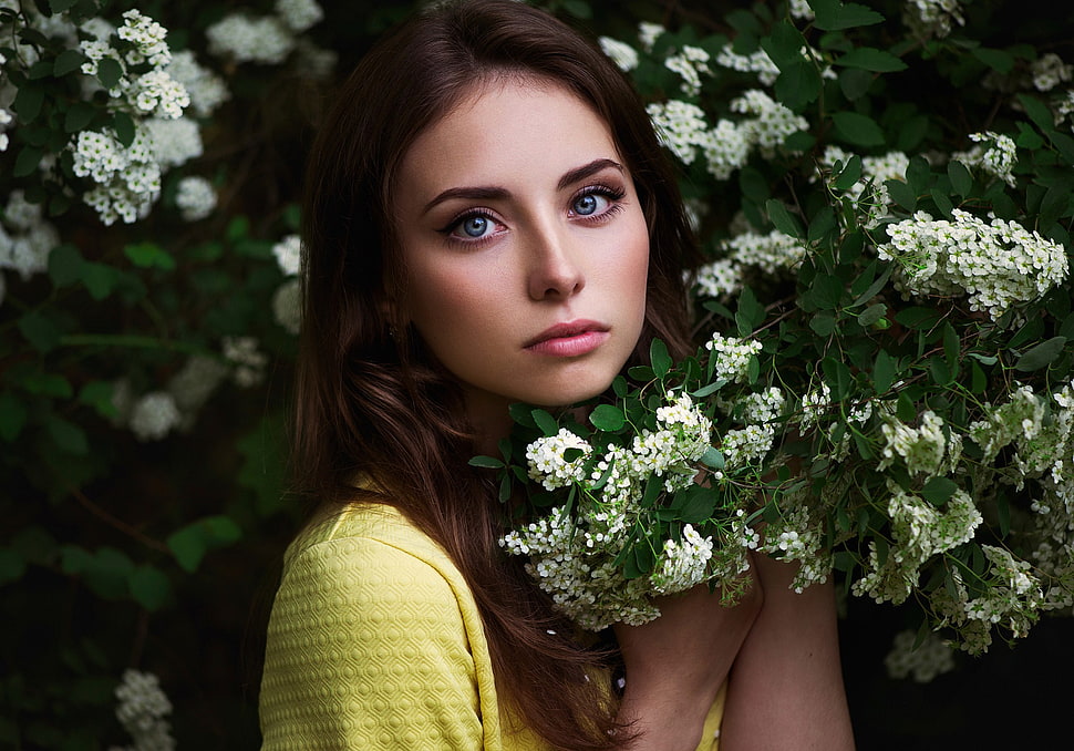 woman wearing yellow tops holding white flowers closeup photography HD wallpaper