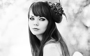 gray scale photo of woman with flower fascinator hat