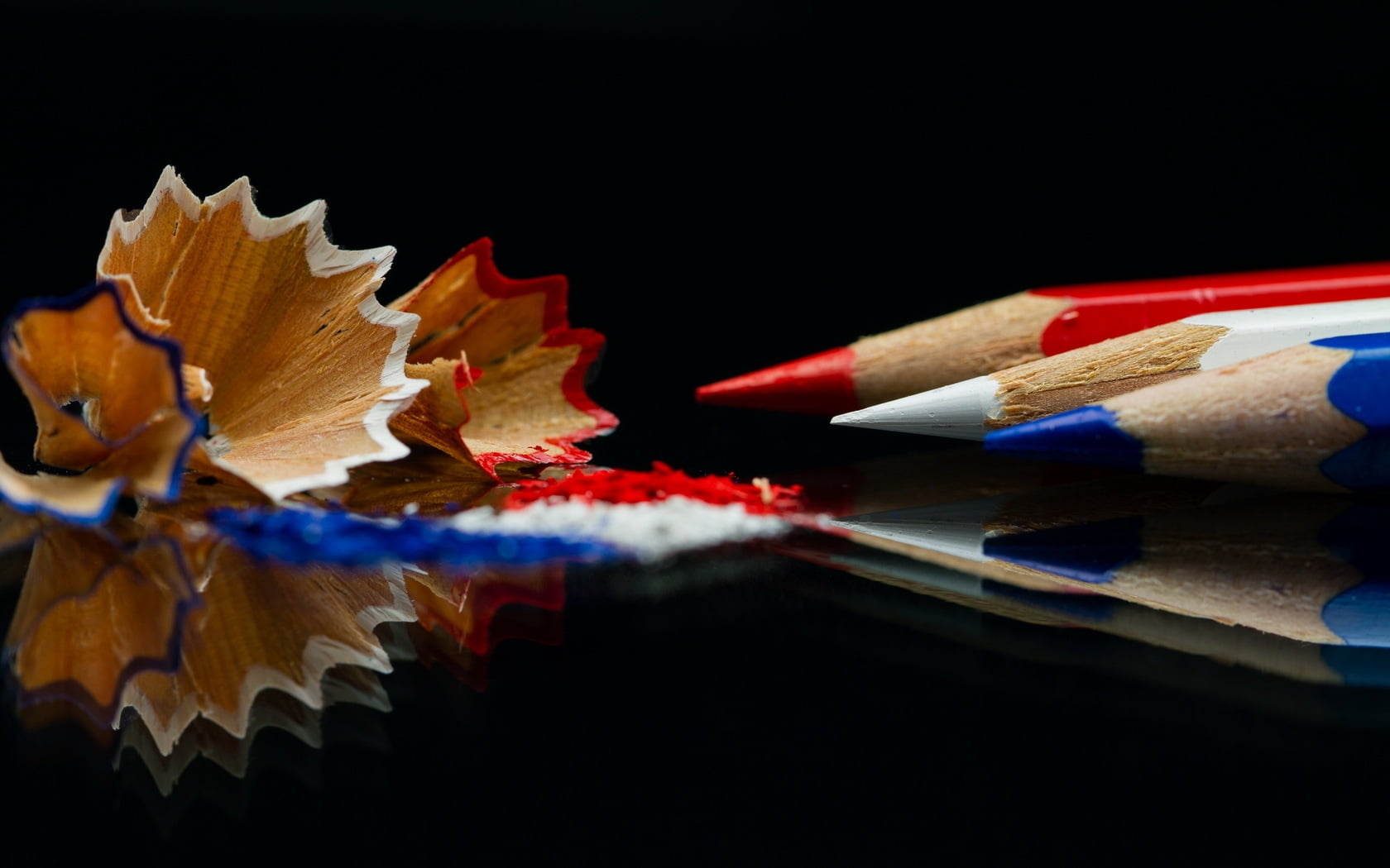 white pencil in middle of blue and red colored pencils