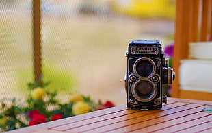 Rolleiflex twin-lens reflex camera on wooden table