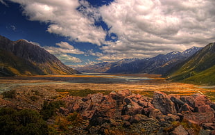 green mountains under white clouds