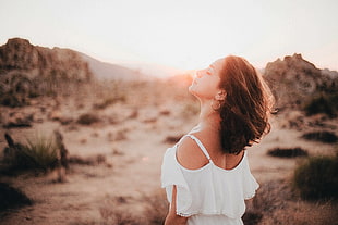 woman wearing white cold shoulder dress