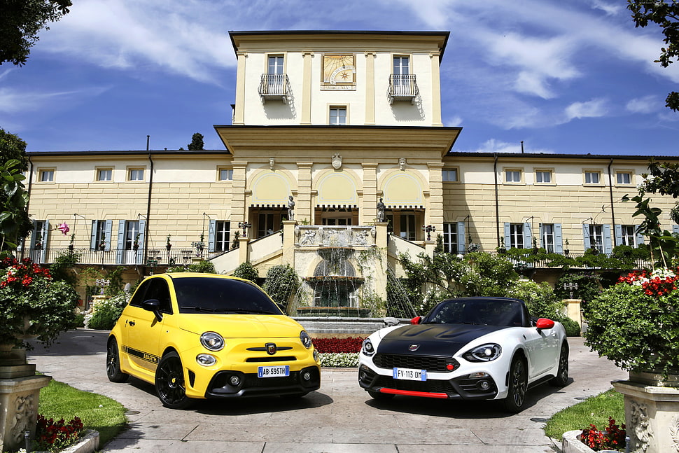 yellow and white concept cars in front of yellow and white concrete house during daytime HD wallpaper