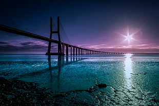 bridge on body of water during day time HD wallpaper