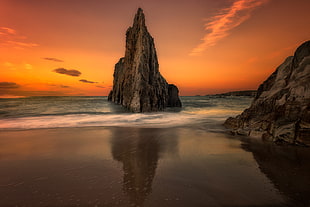 rock formation on seashore during golden hour HD wallpaper