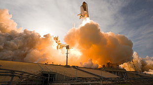 space shuttle launching from platform to the sky at daytime