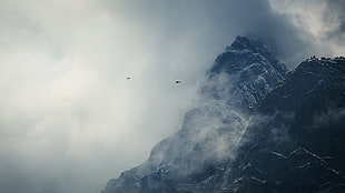 black mountain covered with clouds