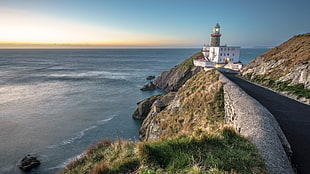 light tower on cliff beside body of water, baily lighthouse, dublin, ireland HD wallpaper