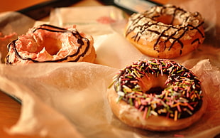 doughnuts with cream and sprinkles on top HD wallpaper