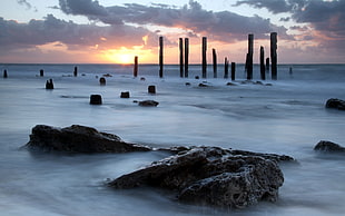 fogged rock formation in distance of sunset