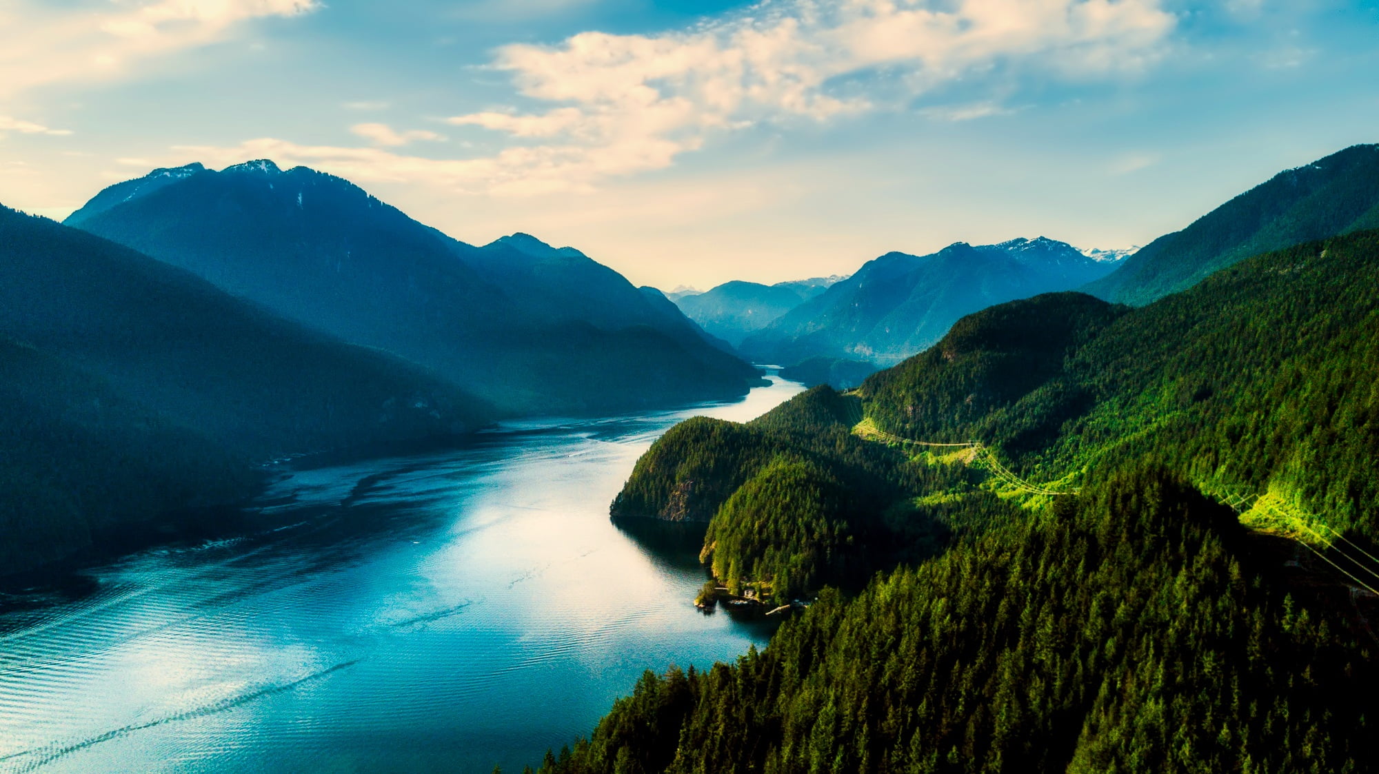 lake in between hills during daytime