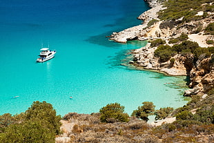 white yacht on sea water near shore during daytime