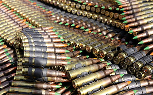 gold-black-and-green gun bullets lot HD wallpaper