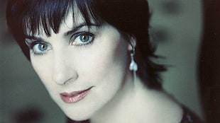 shallow focus portrait photography of woman with heart-shaped dangling earring