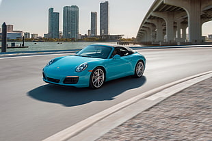 teal Porsche 911 along highway near bridge HD wallpaper