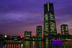 photography of high-rise building under purple sky during night time HD wallpaper