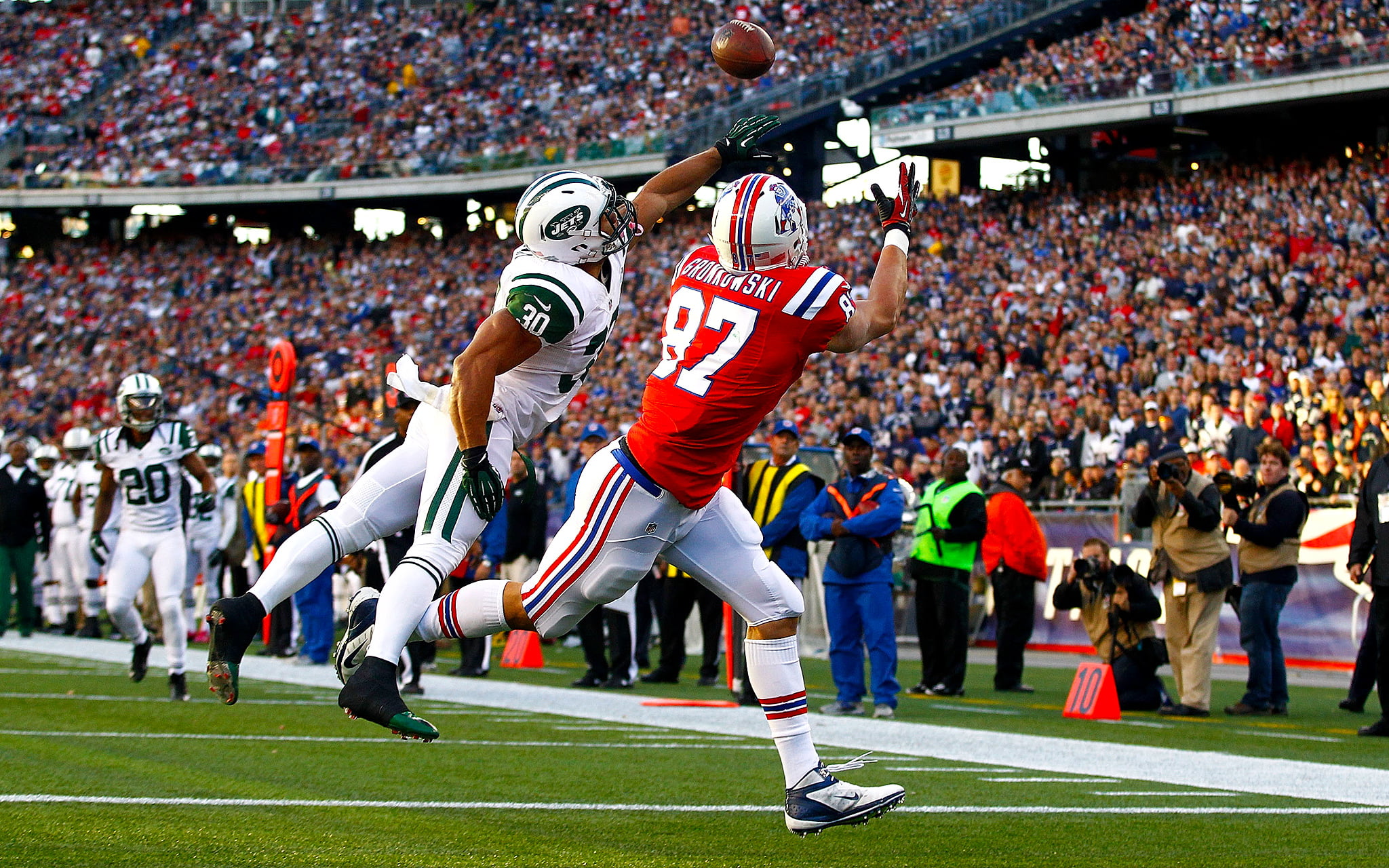 two American football players catching ball near white line